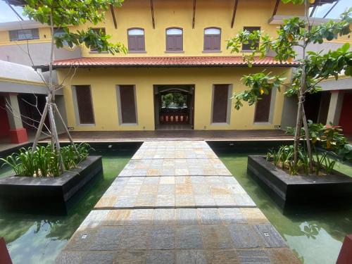 a courtyard of a building with water and trees at Adaar in Trincomalee