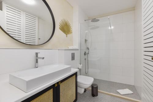 a bathroom with a sink and a toilet and a mirror at Dimitris Residence in Tivat