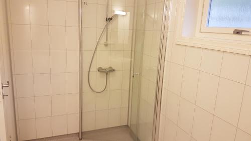 una ducha con puerta de cristal en un baño en Veganeset Camping, en Balestrand