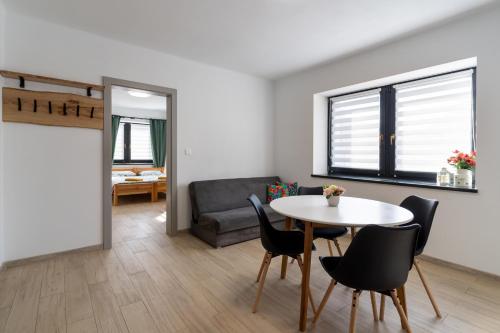a living room with a table and chairs and a couch at Apartments Žiar 114 in Žiar