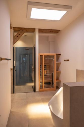 a bathroom with a bath tub and a skylight at Reethus 22 Loft 6 in Timmendorfer Strand