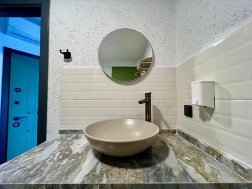 a bathroom with a large bowl sink on a counter at Elm pansiyon in Fethiye