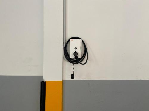 a phone hanging on a wall with a chain at Hotel Europa in Verona