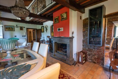 a living room with a fireplace and a table at Il Casale La Duchessa in Vetulonia