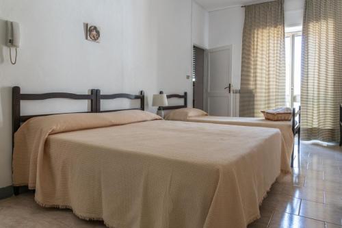 a bedroom with two beds in a room at La casa dei Nonni in San Giorgio Lucano