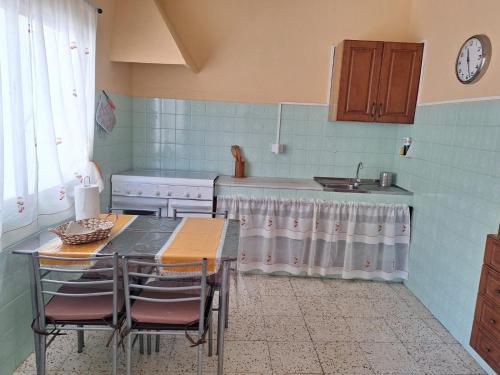 a kitchen with a table and chairs and a sink at Casa Restinga in La Restinga
