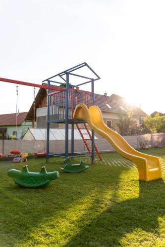 a playground with a slide in the grass at Apartments Žiar 114 in Žiar