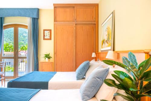 Postel nebo postele na pokoji v ubytování Albergo Il Giardino del Rio