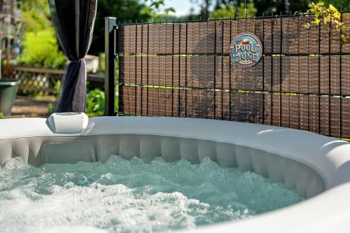 a jacuzzi tub filled with water in a yard at Ferienwohnung Lydia in Zell am Harmersbach