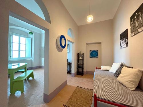a living room with a couch and a table at Faro Capel Rosso in Isola del Giglio