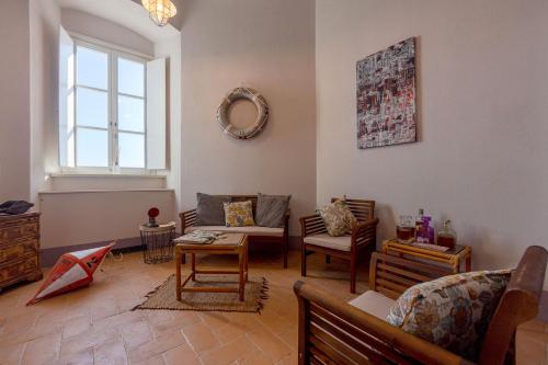 a living room filled with furniture and a window at Faro Capel Rosso in Isola del Giglio