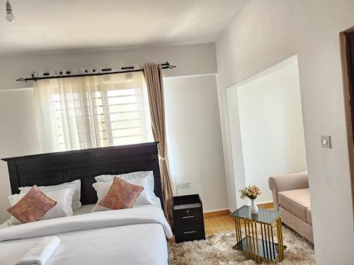 Postel nebo postele na pokoji v ubytování Jay's apartment