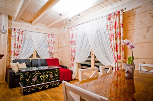a living room with a table and a couch at Domki Prokop in Ciche