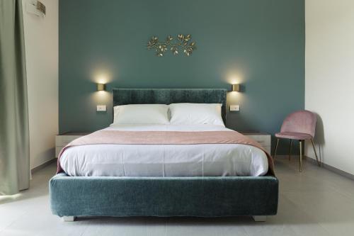 a bedroom with a large bed with a green bed frame at Casale Auriga - Oltrepo' Pavese in Codevilla