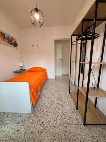 a bedroom with a bed with an orange blanket at La Ginestra in Roccascalegna