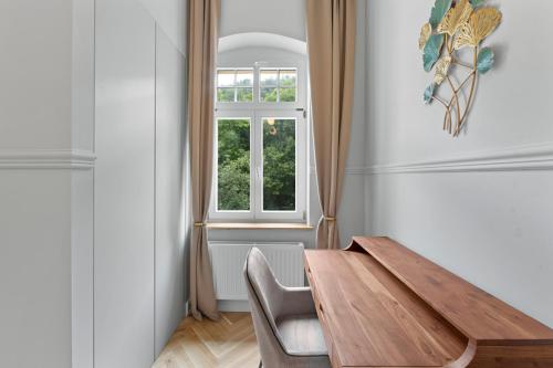 a dining room with a wooden table and a window at Residenz Hugo in Bad Schandau