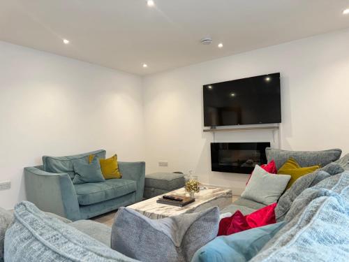 a living room with two couches and a tv at Eagles Cottage, 3 - Bed, Sleeps 6, Pets Welcome - Ulverston in Ulverston
