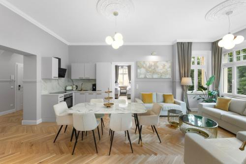 a kitchen and living room with a table and chairs at Residenz Hugo in Bad Schandau