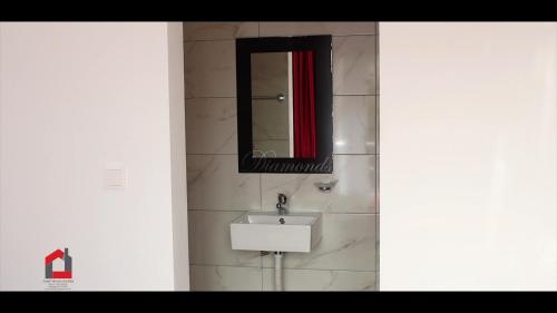 a bathroom with a sink and a mirror at Guest House Lina Elisa in Mindelo