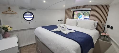 a bedroom with a bed with a stuffed animal on it at Luxury Boat Stay Liverpool sleeping 6 WiFi in Liverpool