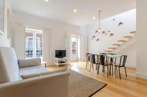 a living room with a couch and a table at Light House Apartments - Casas da Baixa in Lisbon