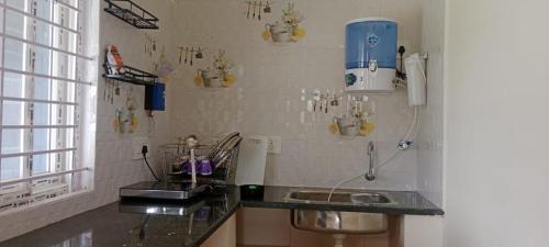 a kitchen with a counter with a sink and a window at Homestay Near Nandi, Muddenahalli in Bengaluru