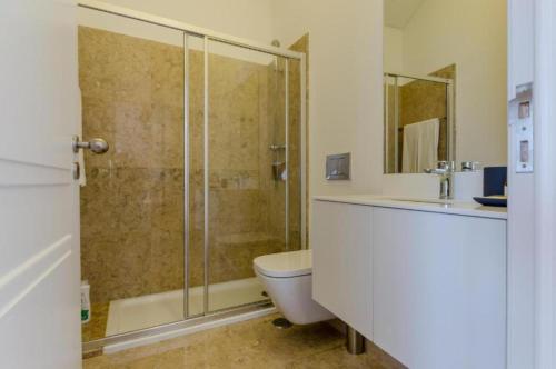 a bathroom with a shower and a toilet and a sink at Light House Apartments - Casas da Baixa in Lisbon