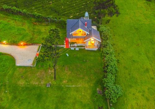 an overhead view of a house on a green field at AJ Gable Clouds Ooty by VOYE HOMES - Serene Stay Near Avalanche Emerald Lake in Ooty