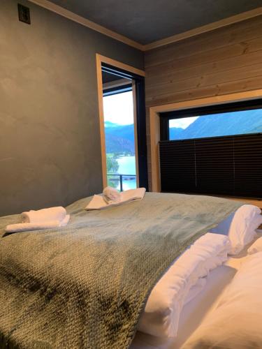a bedroom with a large bed with a large window at Stryn Golden Resort - Panorama II in Stryn