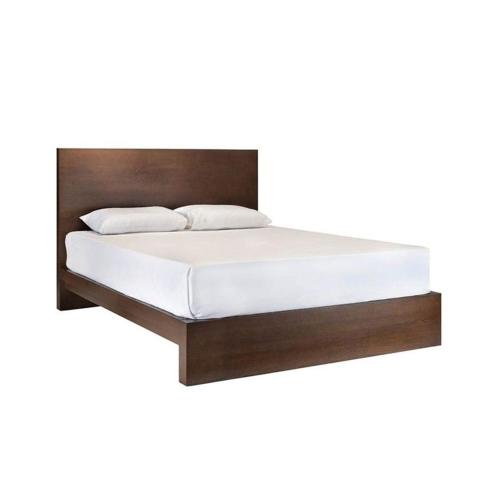 a bed with a wooden headboard and white mattress at Bosadi Homestay in Katunayake