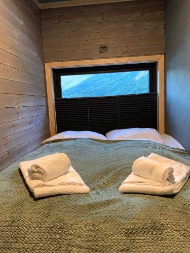 a bedroom with a bed with two towels on it at Stryn Golden Resort - Panorama II in Stryn