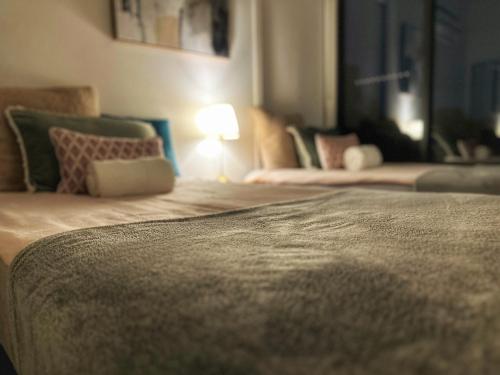 a bedroom with two beds with a lamp on it at 89B - Your Dream Stay Business or Travel Mornings with coffee in Bentleigh in Heatherton