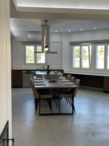 a dining room and kitchen with a table and chairs at Pervolia Oasis Villa in Kiti
