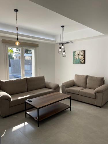 a living room with two couches and a coffee table at Pervolia Oasis Villa in Kiti