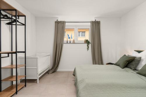 a white bedroom with a bed and a window at EasyTree 4P Switch TV in Bad Driburg