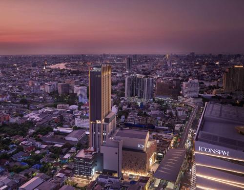 an aerial view of a city at night at Hilton Garden Inn Bangkok Riverside in Bangkok