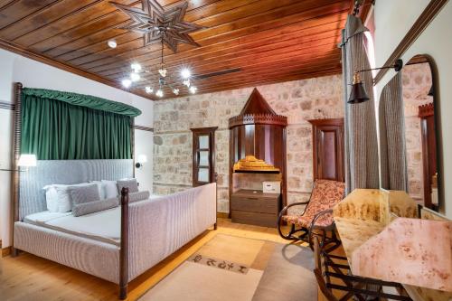 a bedroom with a bed and a table and a chair at House 5 Hotel in Antalya
