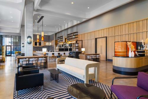 a lobby of a hotel with a couch and tables at Hyatt Place Nashville/Green Hills in Nashville