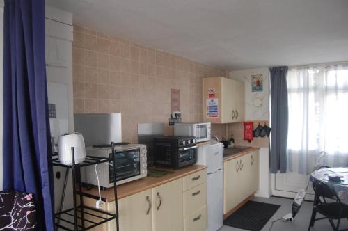 a kitchen with a counter with a microwave and appliances at Dawlish Warren Welcome family holiday park Fern villa Welcome2Warren South Devon in Dawlish Warren