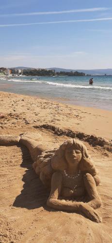a sand sculpture of a mermaid on a beach at Sea Apartament Kristal Beach,Nessebar in Nesebar