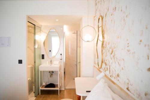 a white bathroom with a sink and a mirror at Citrea Santander in Santander