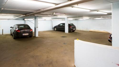 two cars are parked in a parking garage at Residenz Donaucity in Vienna