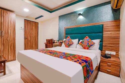 a bedroom with a large bed in a room at FabExpress Amber Corp Inn - Nr NESCO Exhibition Center in Mumbai