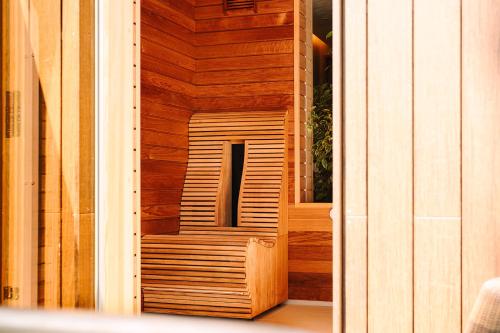 a wooden sauna with a wooden bench in a building at South Lodge in Lower Beeding
