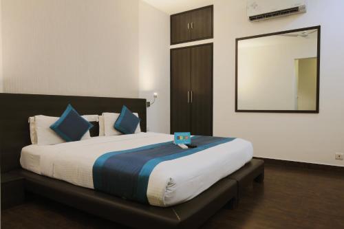 a bedroom with a large bed with a mirror at The Saneer Jaipur in Jaipur