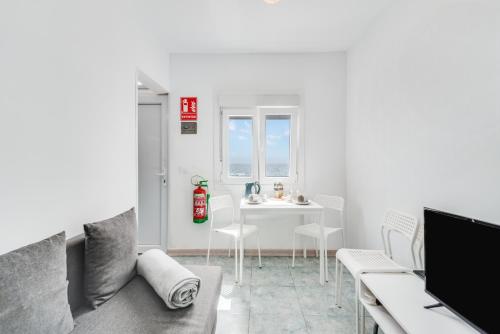 a living room with a couch and a table at Home2Book Stunning BeachFront Apt, Pozo Izquierdo in Pozo Izquierdo