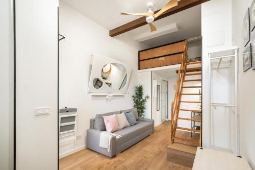 a living room with a couch and a loft bed at Estudio en Plaza de España in Madrid
