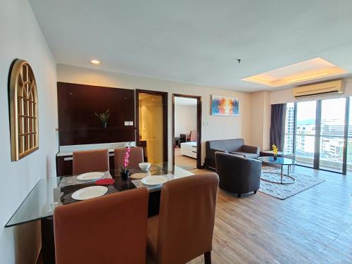 a living room with a dining table and a living room at Greenage MingSuite 明绿时代套房 Kota Kinabalu 亚庇市中心 in Kota Kinabalu