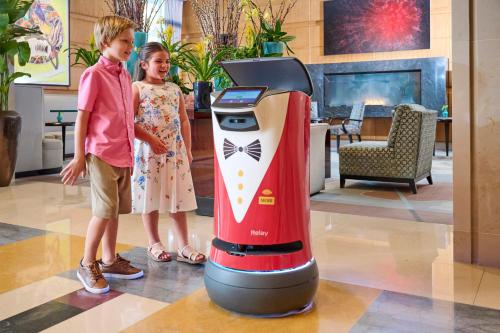 two children standing next to a video game console at Mandarin Oriental, Boston in Boston