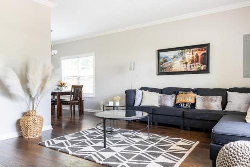 a living room with a blue couch and a table at Stylish and Cozy Retreat in Buford